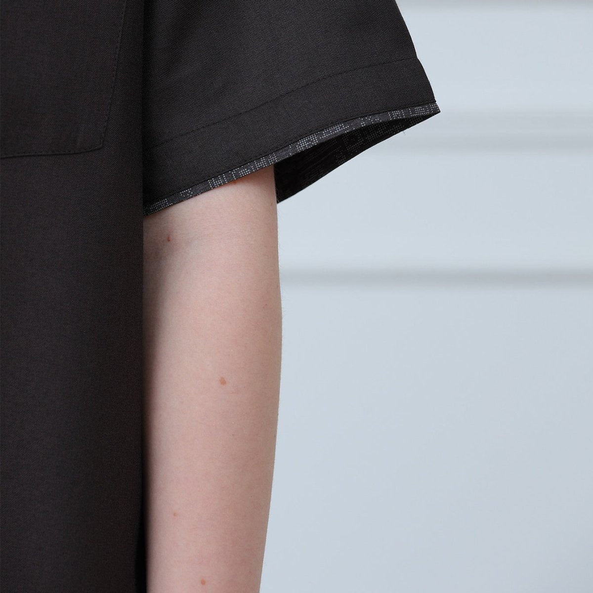 Close-up of tonal geometric embroidery on chest pocket and placket
