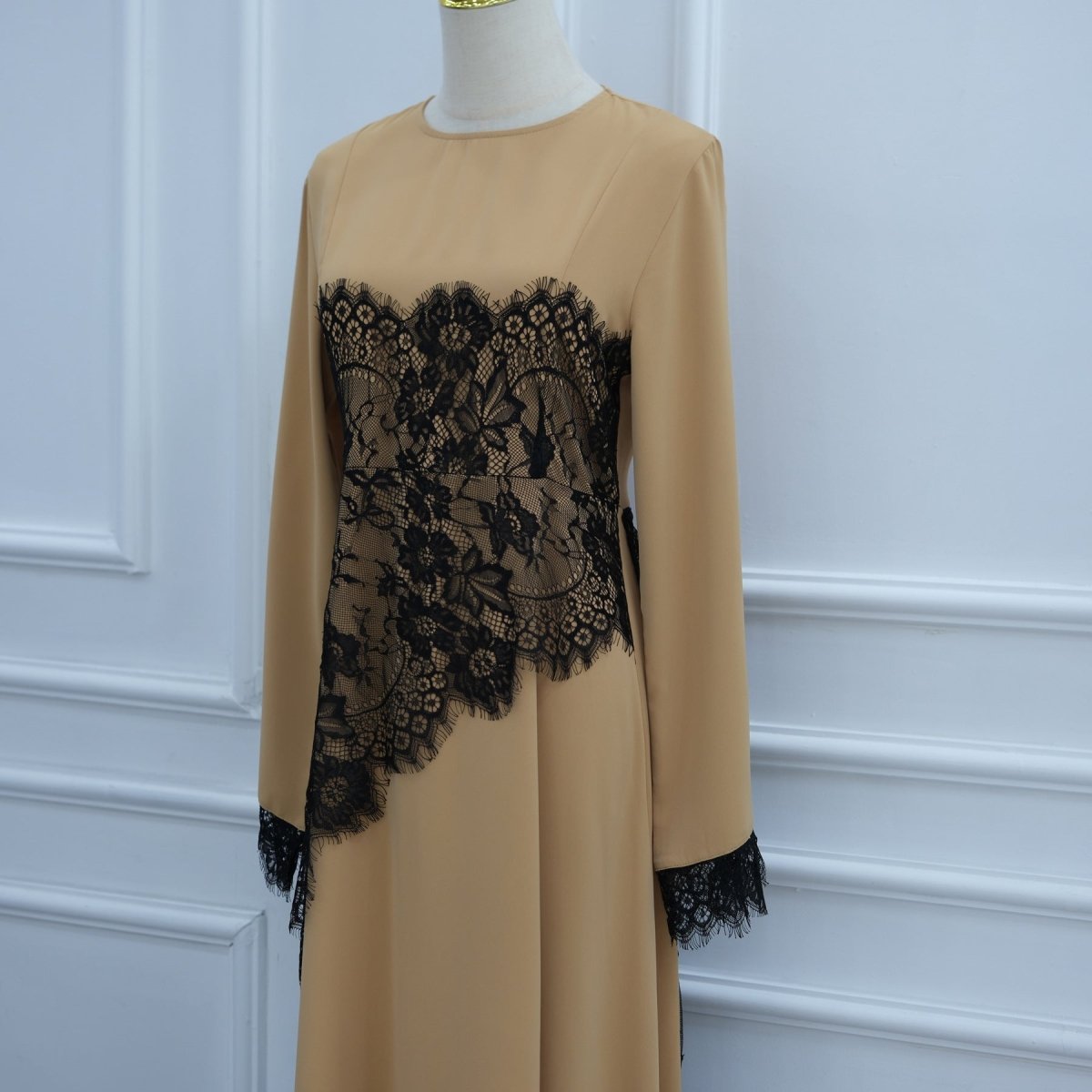 Full-length front view of solid bodice and asymmetric lace overlay