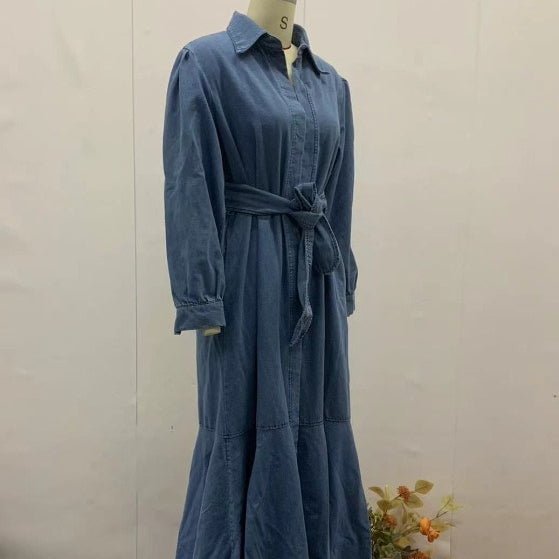 Close-up of fabric tie belt cinching the denim chambray waistline