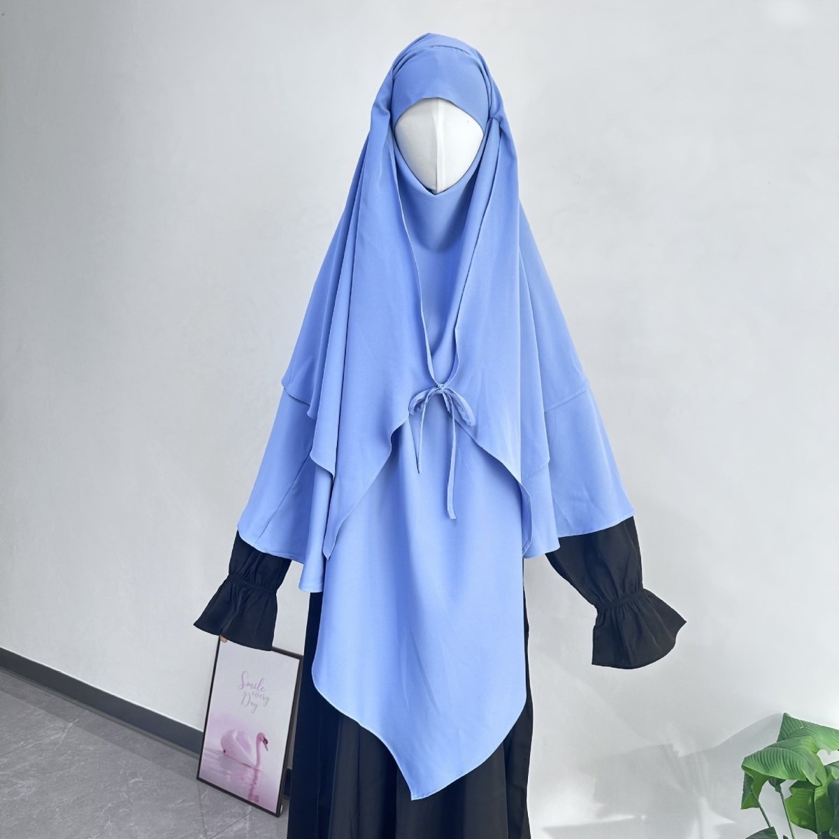 Pointed asymmetric hem detail on front of tie-front khimar