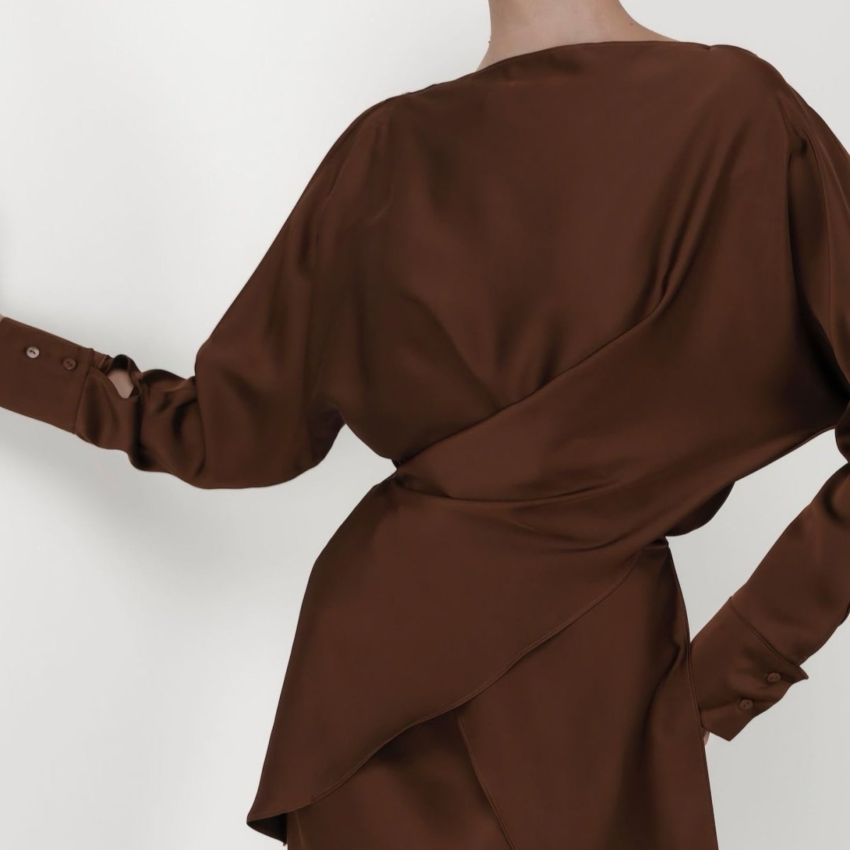 Close-up of sculptural draping on satin wrap top bodice