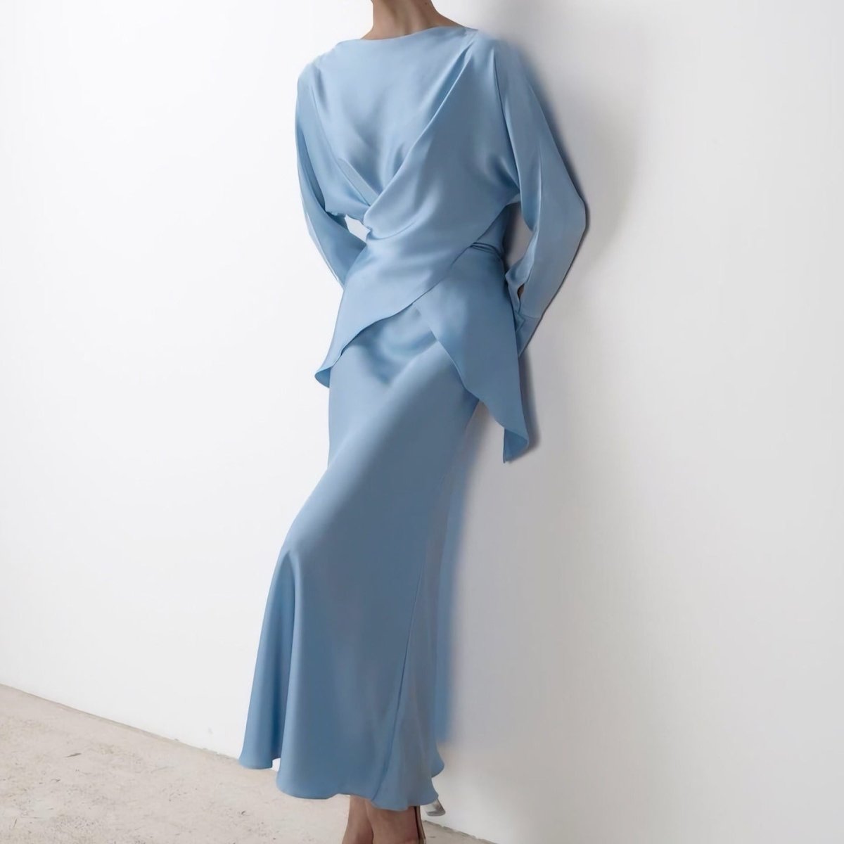 Draped peplum movement on satin wrap top