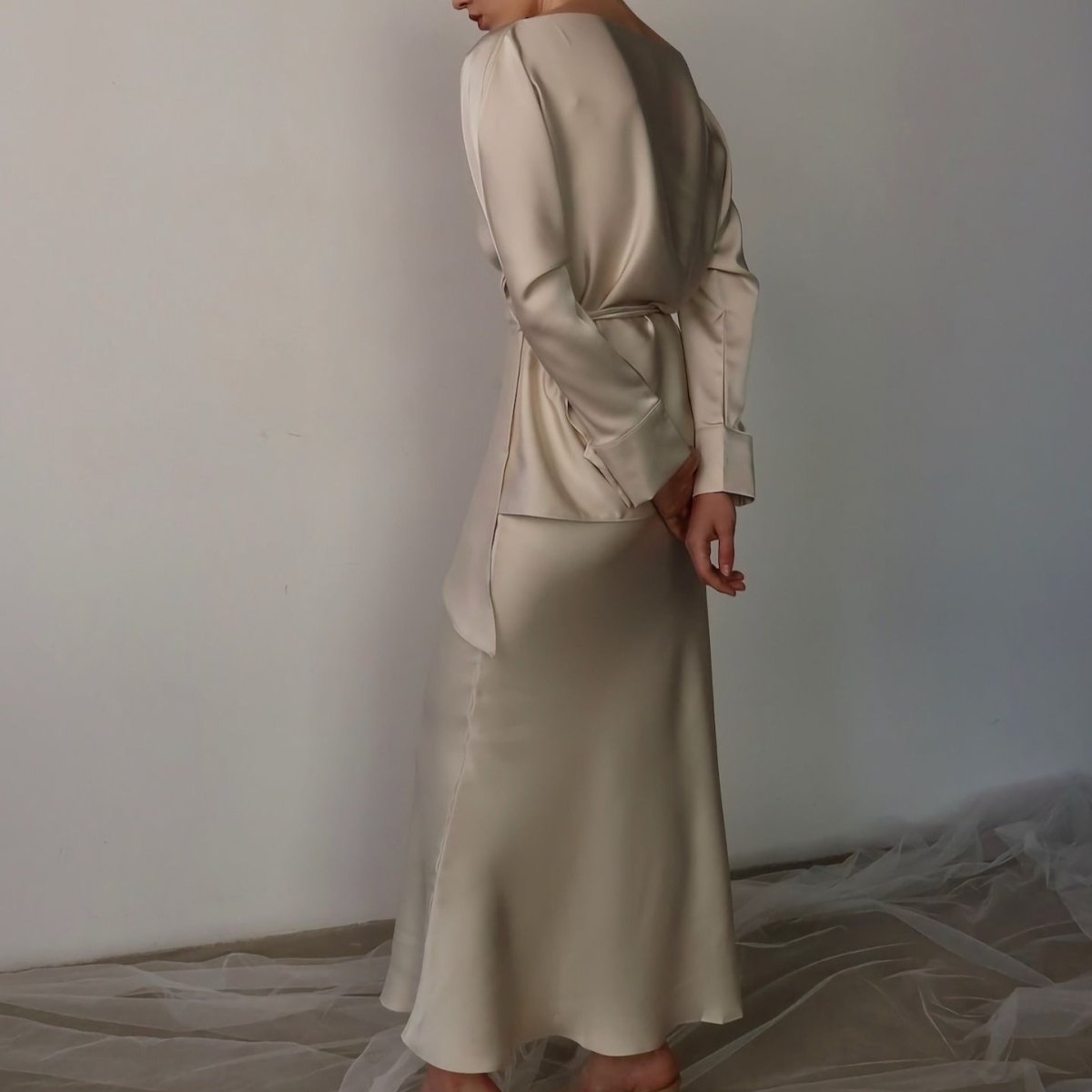 Boat neckline detail on draped satin wrap top