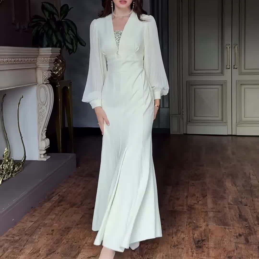 Full-length side view of empire waist formal dress in pristine white