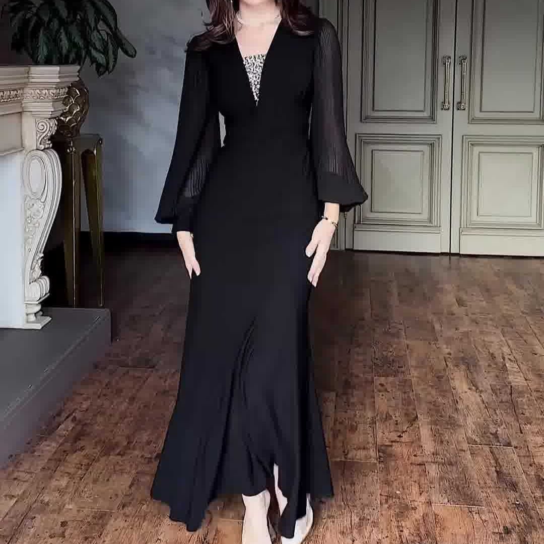 Three-quarter view of empire waist satin gown in classic black