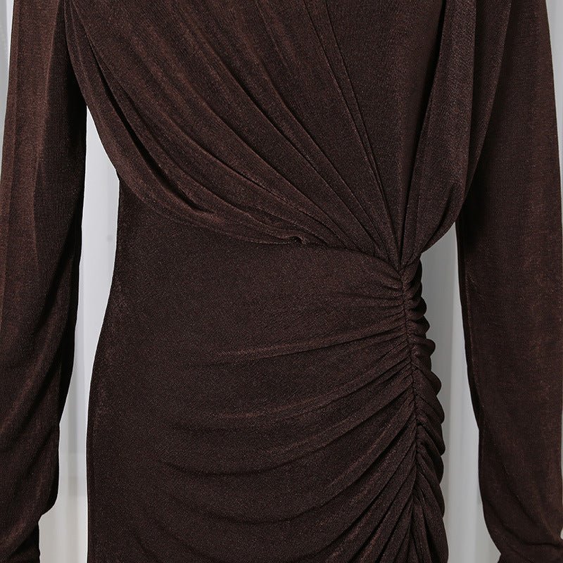 Close-up of diagonal pleating detail across the bodice of the formal gown
