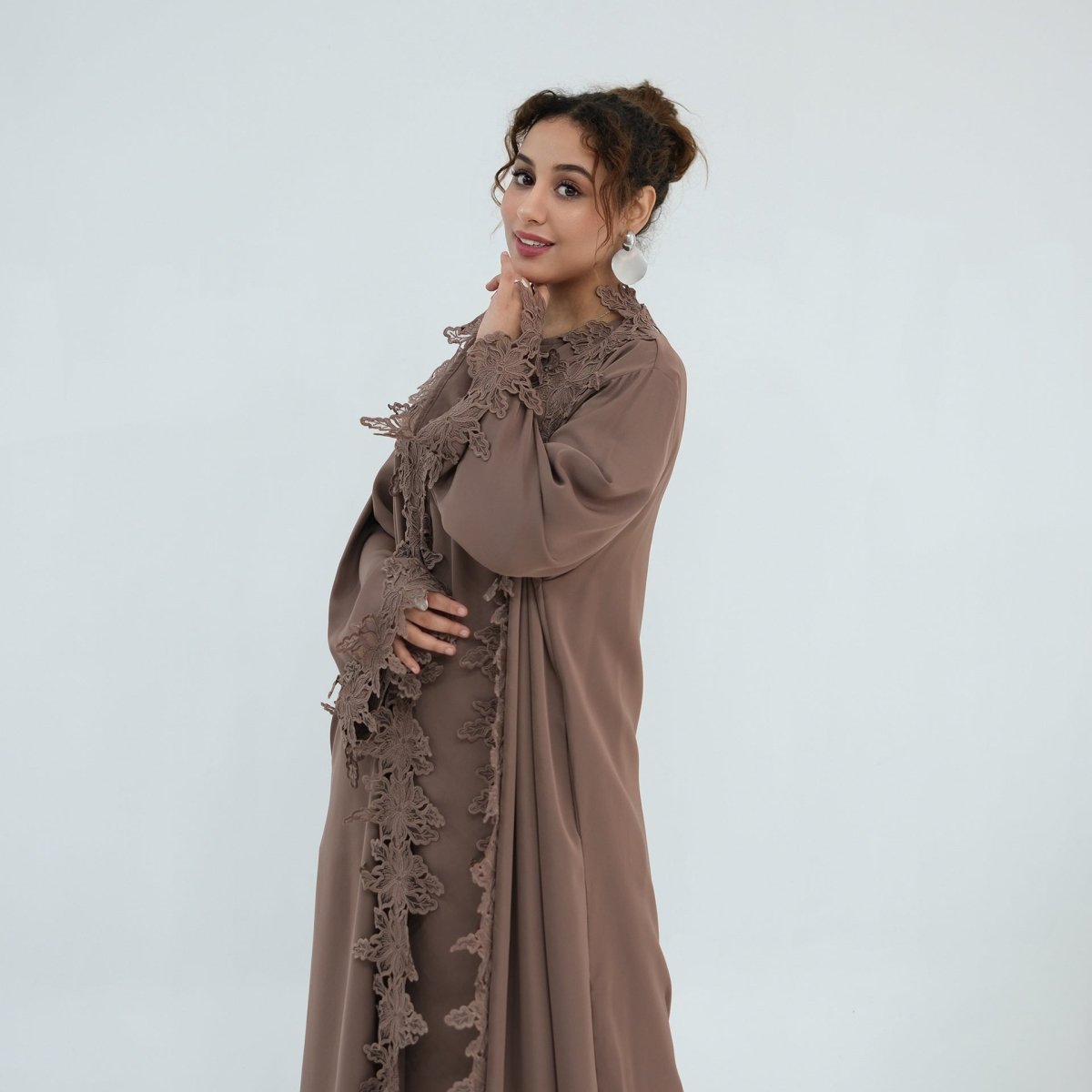 Tonal lace trim across abaya sleeve cuff