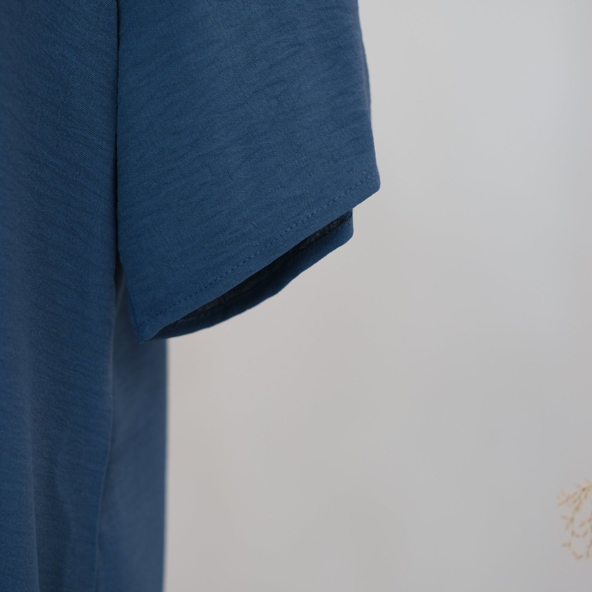 Side profile of white ice silk crinkle inner dress showing oversized drape