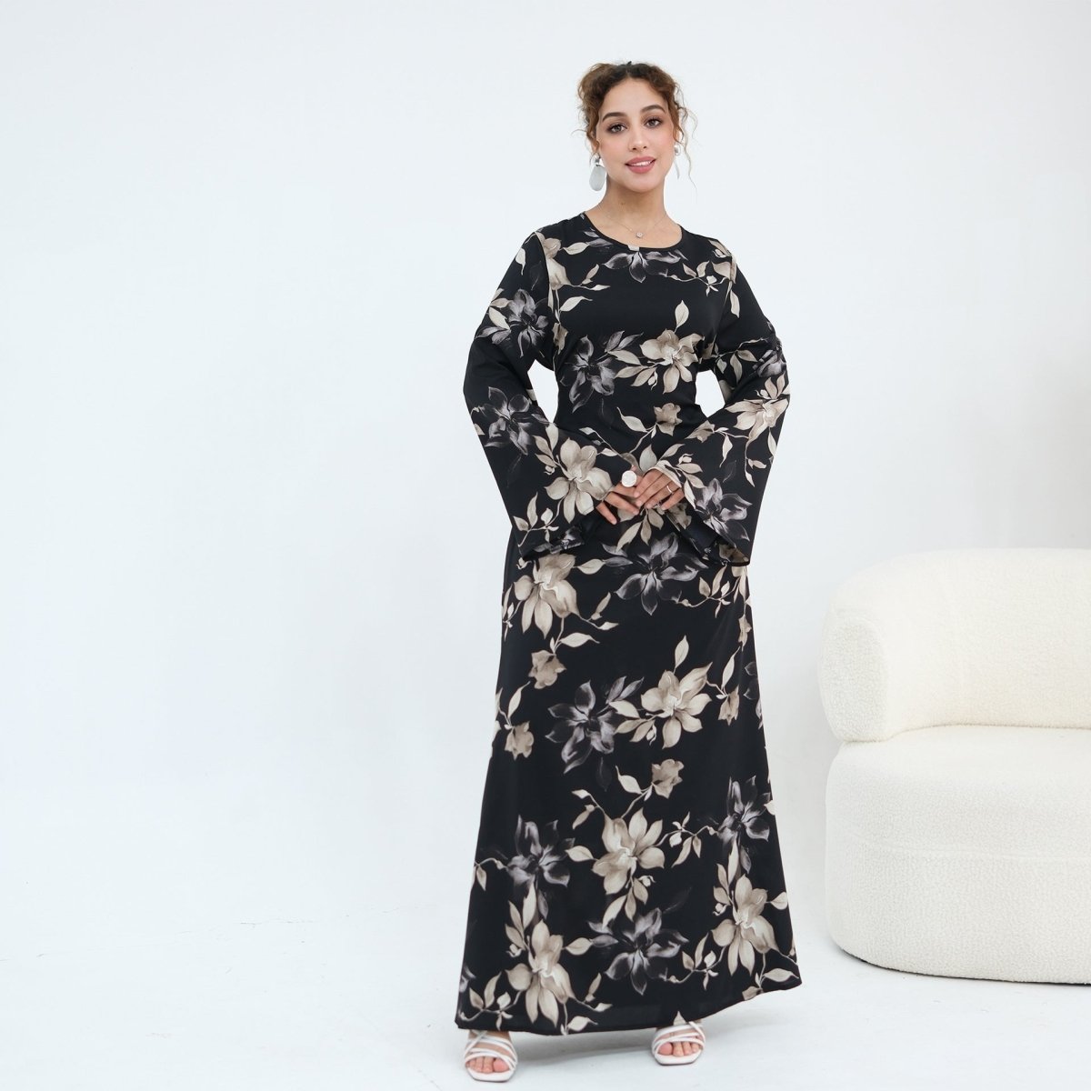 Model wearing ink floral satin maxi dress styled for an evening occasion