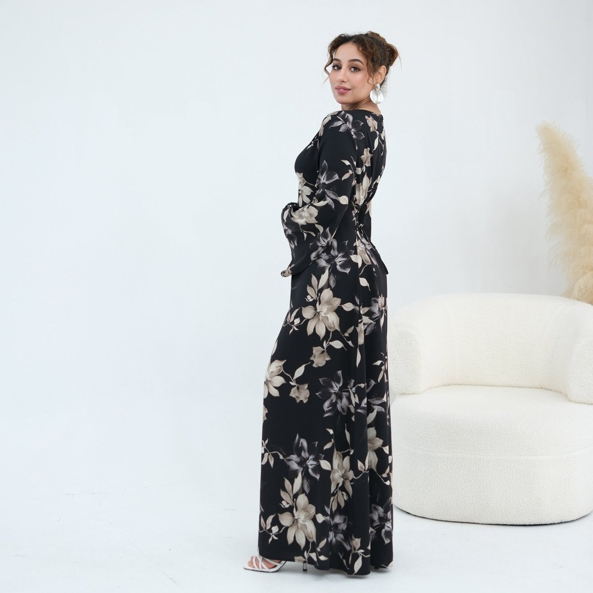 Trailing petal and leaf print close-up on satin bell sleeve maxi dress