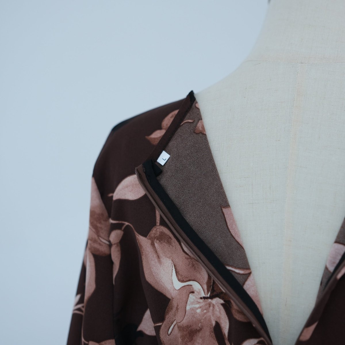 Full-length view of ink floral dress showing A-line skirt falling to the floor