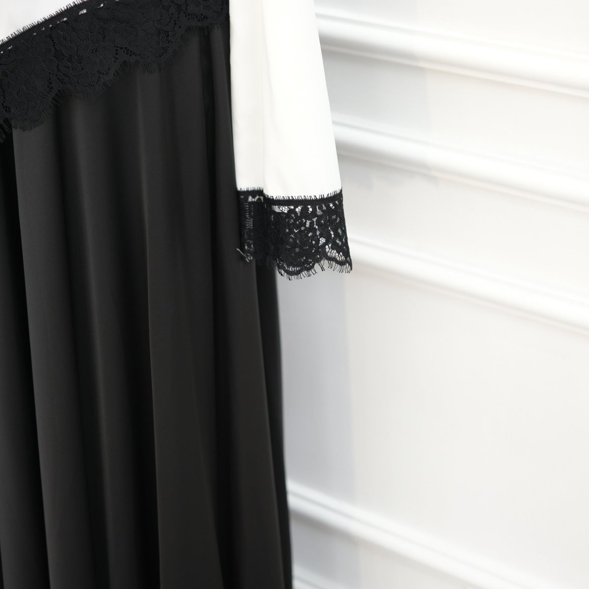 Back neckline button closure detail on lace trim satin top