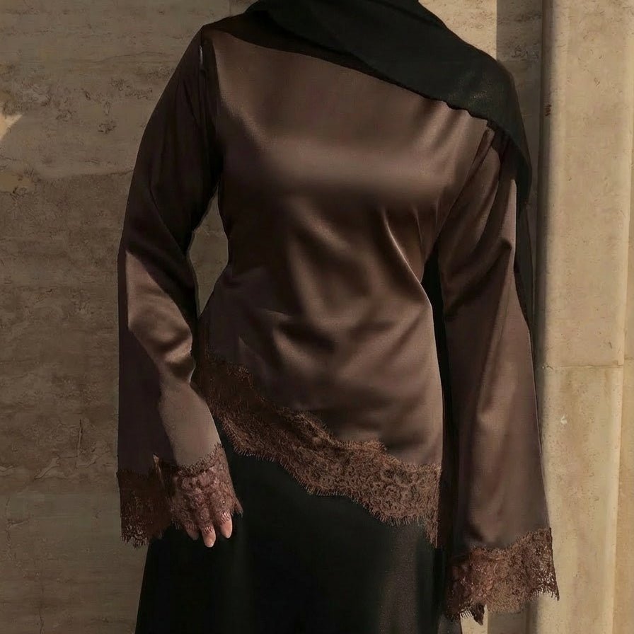 Close-up of wide bell sleeves with contrast lace cuff trim