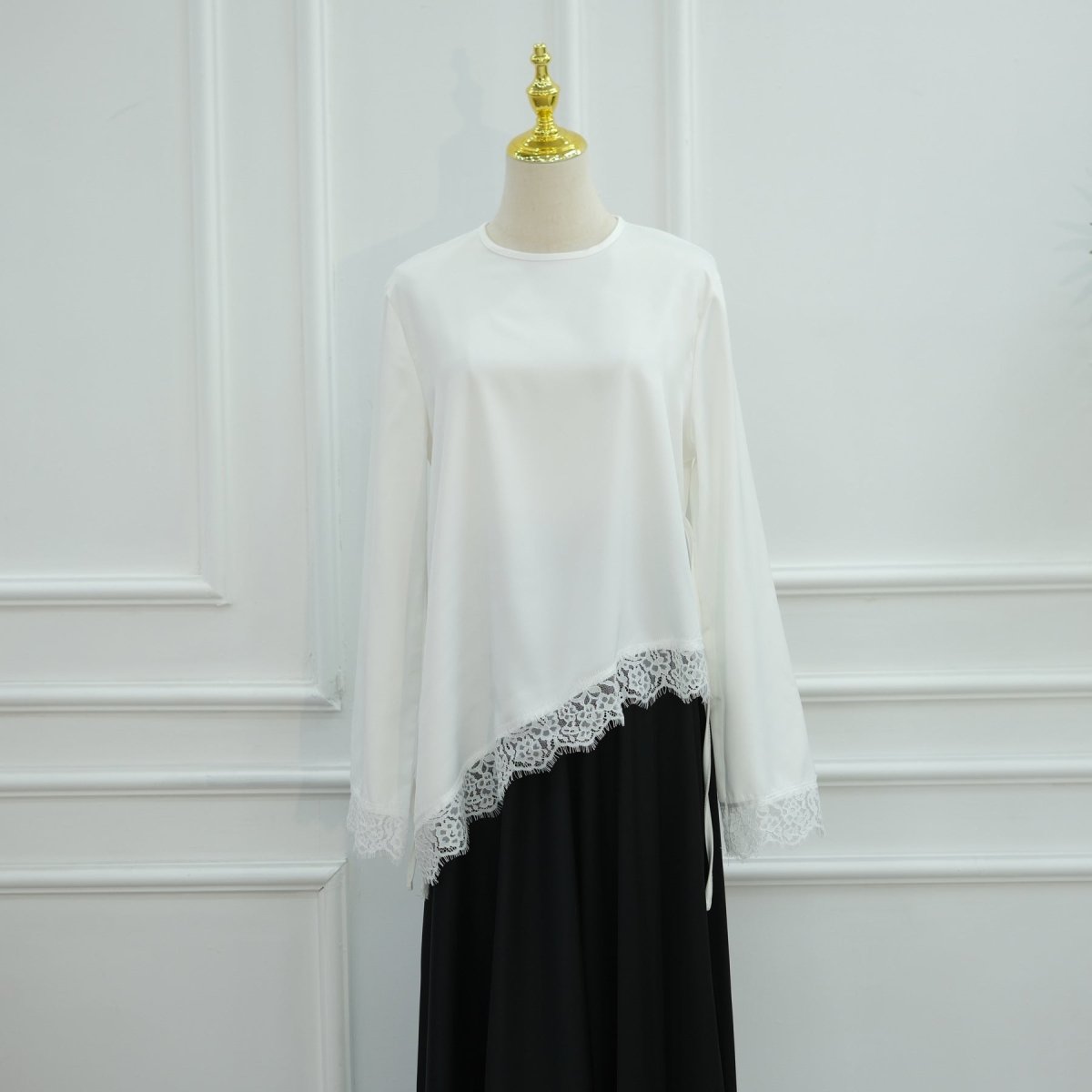 Flowing bell sleeve detail against studio background