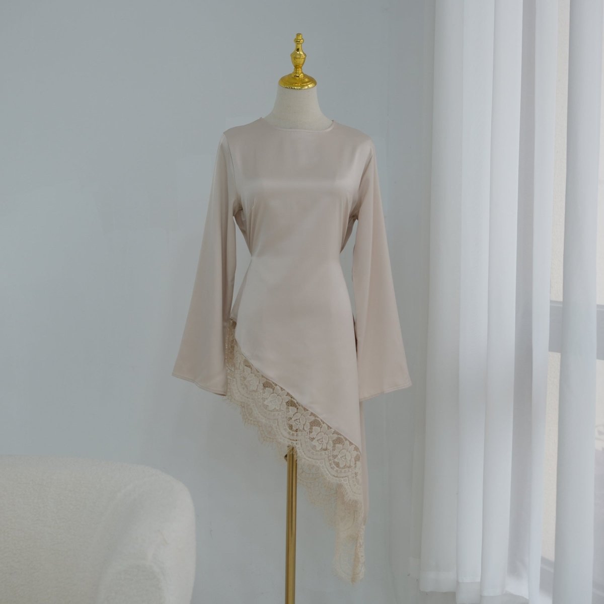 Lace trim satin top draped loosely showing flowing silhouette