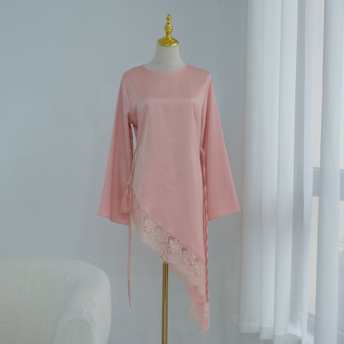 Back view showing diagonal contrast lace panel across lower back