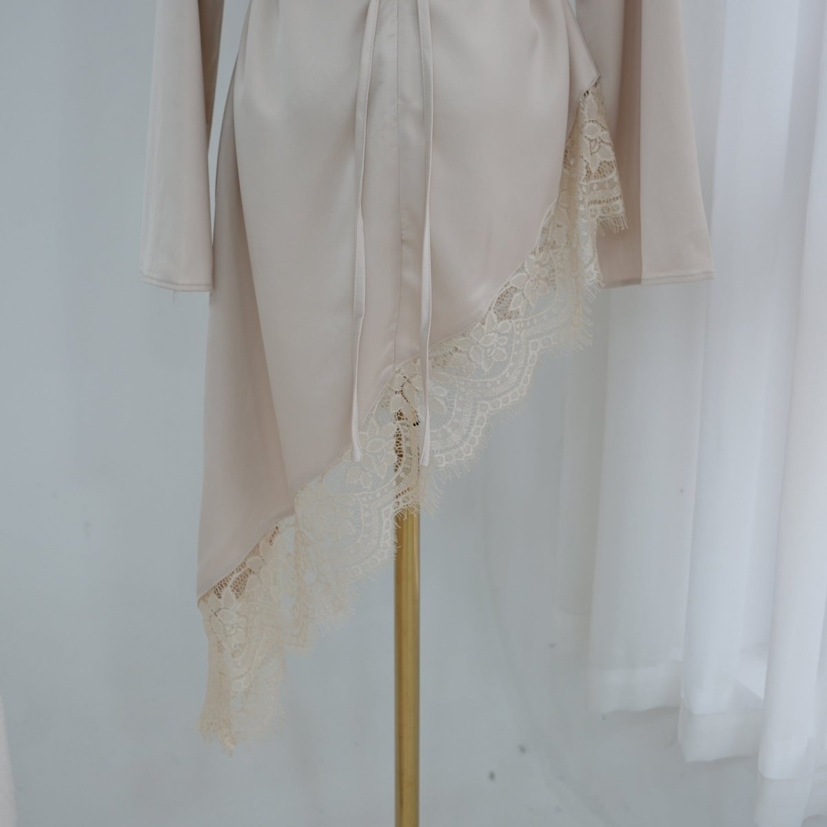 Flowing bell sleeves in motion on satin top