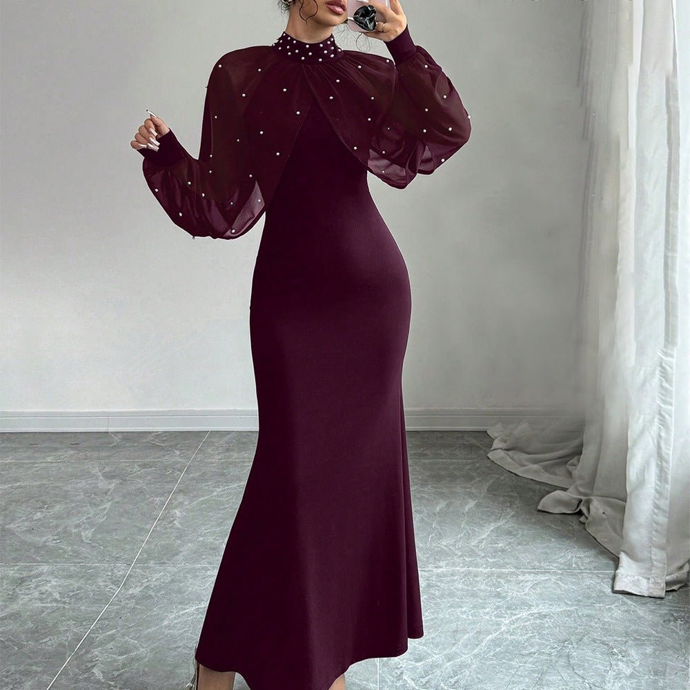 Fitted silhouette of pearl-adorned black maxi dress from front
