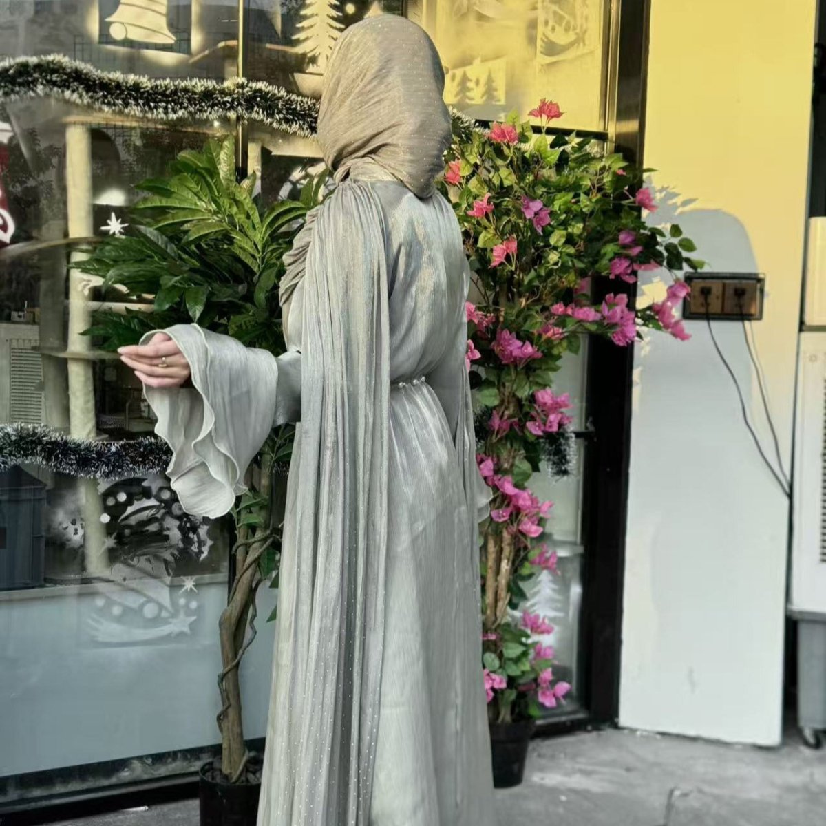 Close-up of luminous island silk fabric on cape sleeve abaya