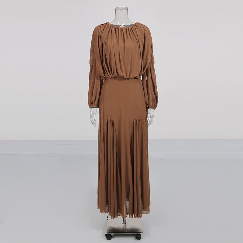 Floor-length pleated skirt detail with sweeping pleats