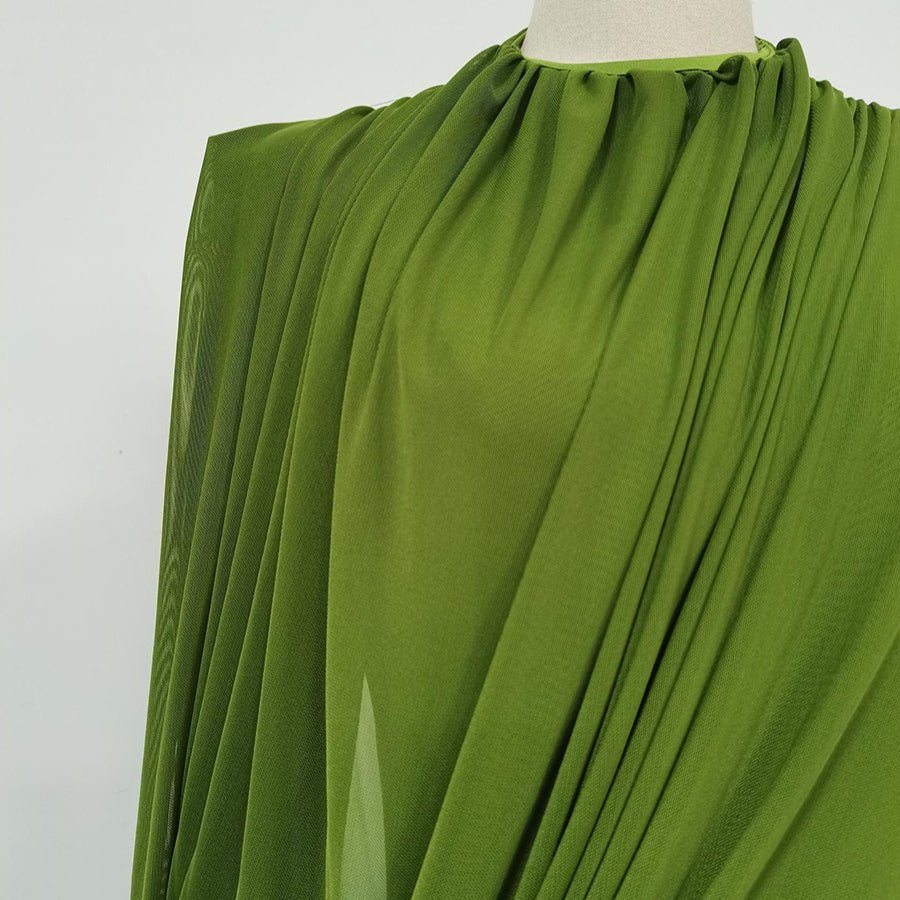 Side profile of floor-length fitted skirt on ruched evening maxi dress