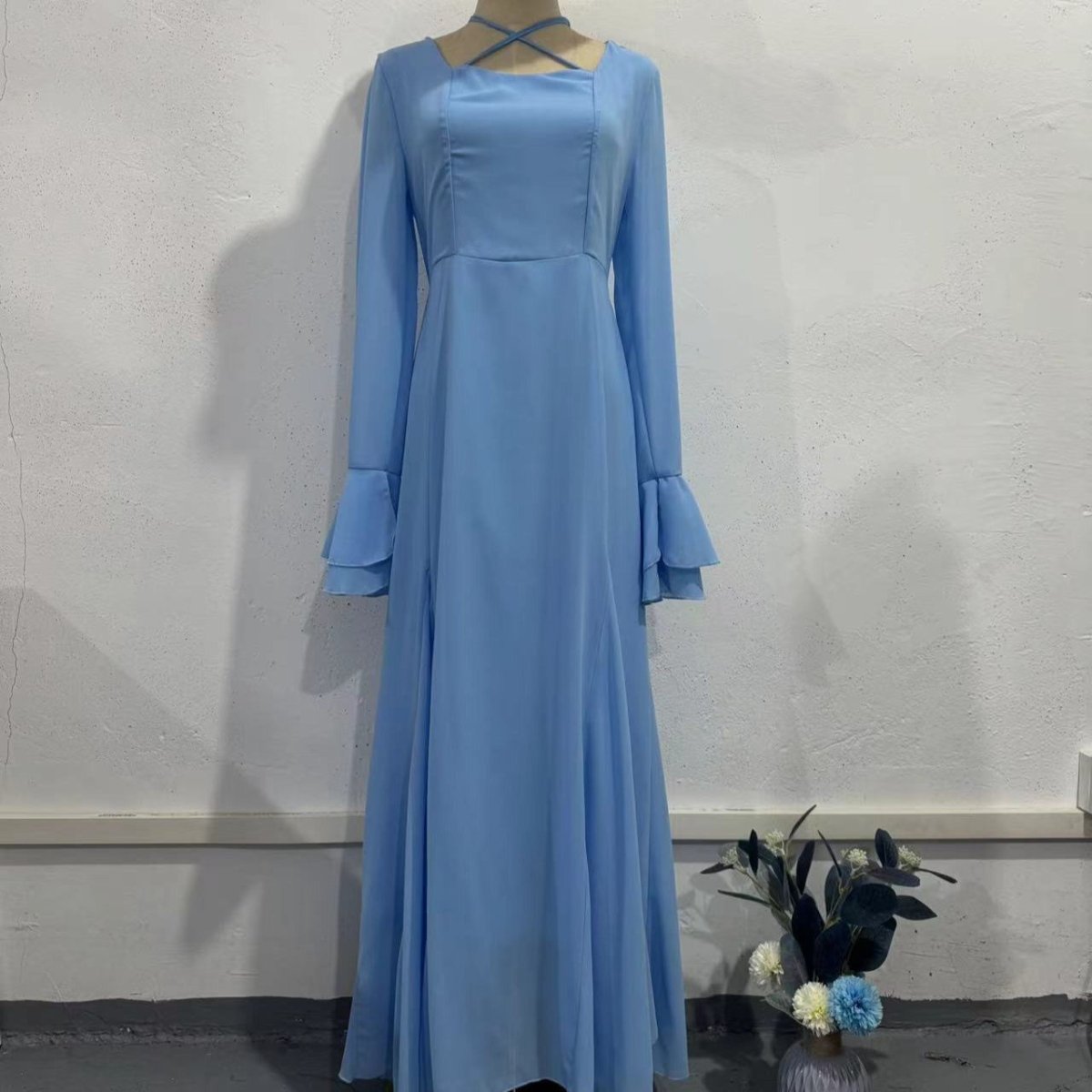 Back view of ruffle sleeve chiffon dress showing halter straps