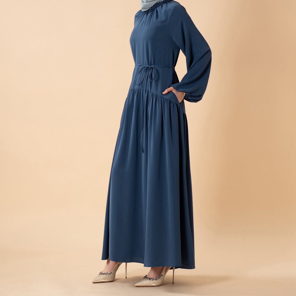 Three-quarter view of ruffle pleated abaya with flowing pleated skirt