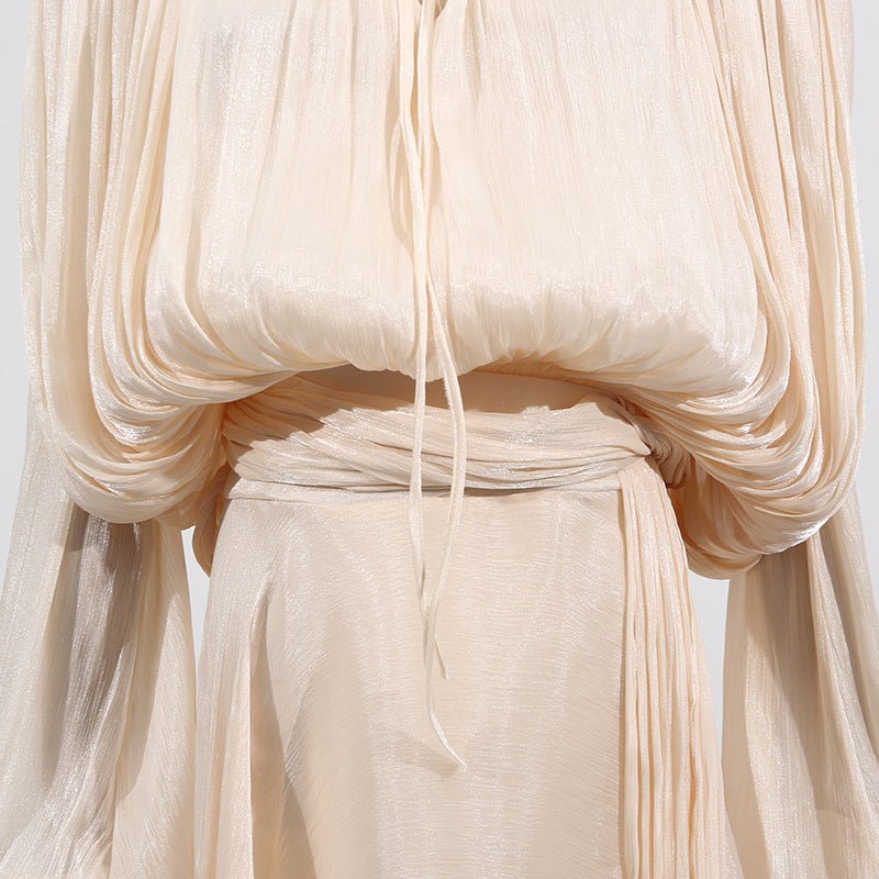 Detail shot of elasticated balloon sleeve cuff on satin blouson dress