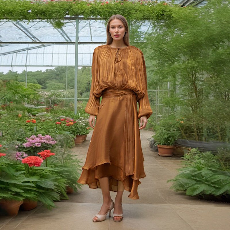Styled flat lay of satin tie-neck blouson dress showing full silhouette and ruffle skirt