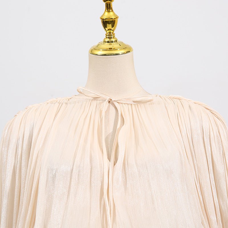 Close-up of gathered tie-bow neckline on premium satin fabric