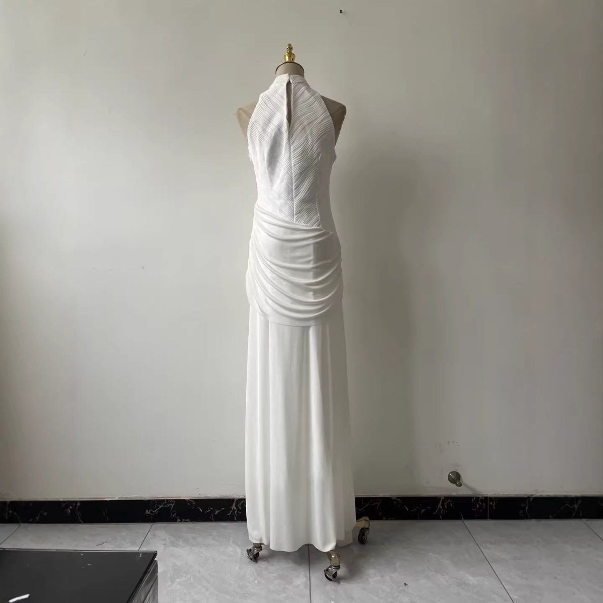Front view of white twisted waist bodycon maxi gown with gold hardware detail