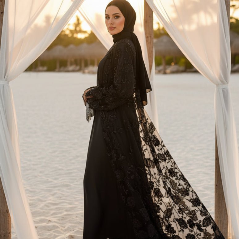Movement shot of sheer couture mesh abaya with light-catching embellishments