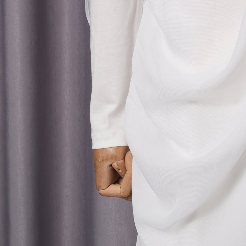Cascading chiffon drape overlay falling along the maxi skirt